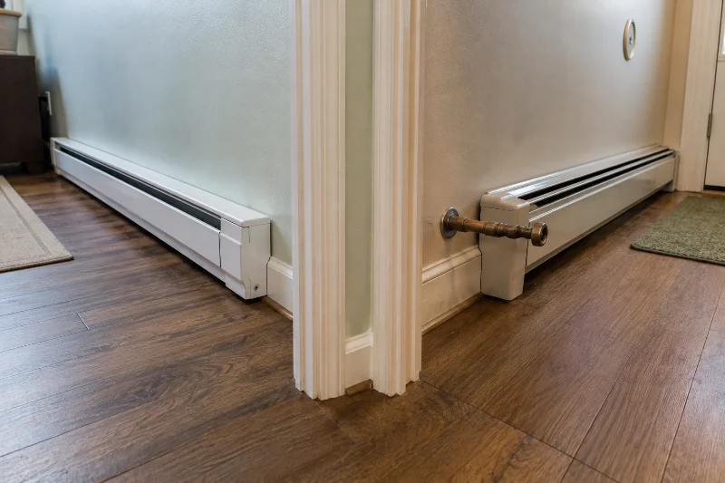Electric and hydronic baseboard heaters compared before cleaning