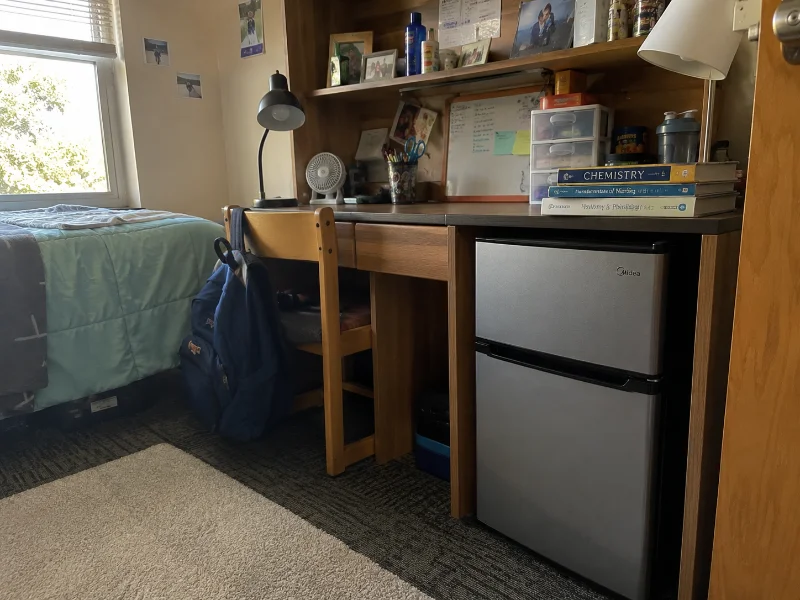 mini fridge with freezer in a dorm room setup